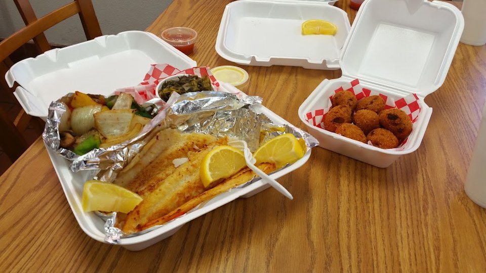 Menu board with fish plates and sides.